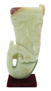 Chinese yellow jade rhyton, 10 inches tall, relief carved with spiraling design, sold through LiveAuctioneers.com for $17,360. Image courtesy Leslie Hindman Auctioneers.
