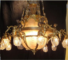 French Neoclassical 12-light bronze chandelier with crystal and bronze chains, $11,500. Don Presley Auctions image.