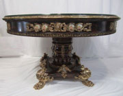 Linke-inspired glass-topped table with gilt bronze and hand-painted porcelain plaques and cartouches, paw feet; one of two to be auctioned. Don Presley Auctions image.