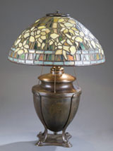 Circa-1905 Tiffany Studios ‘Daffodil’ table lamp with bronze urn-form base, multiple stamps and signatures on shade and base, est. $15,000-$20,000. Quinn’s Auction Galleries image.