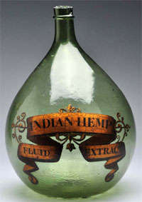 From a 35-year apothecary collection, a 16 ½ in. green demijohn or carboy apothecary show bottle with gold label identifying ‘Indian Hemp Fluid Extract.’ Est. $250-$500. Morphy Auctions image.