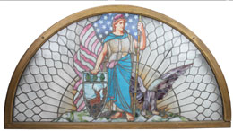 Half-round leaded-glass window featuring Liberty figure, from a Hartford Insurance Co. building, 82in. wide by 44in. tall, est. $7,000-$10,000. Noel Barrett Auctions image.