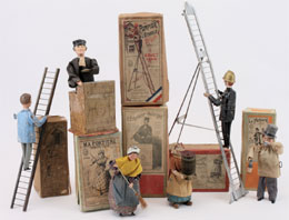 Selection of boxed antique clockwork character toys by the French maker Fernand Martin. Noel Barrett Auctions image.