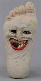 Figural foot-shape Halloween lantern, $4,025. Bertoia Auctions image.