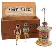 The Automatic Foot Race, 1880s, William Britain & Sons (England), featuring two cloth-dressed figures that trot around a paper-litho metal cylinder, $18,400. Noel Barrett Auctions image.