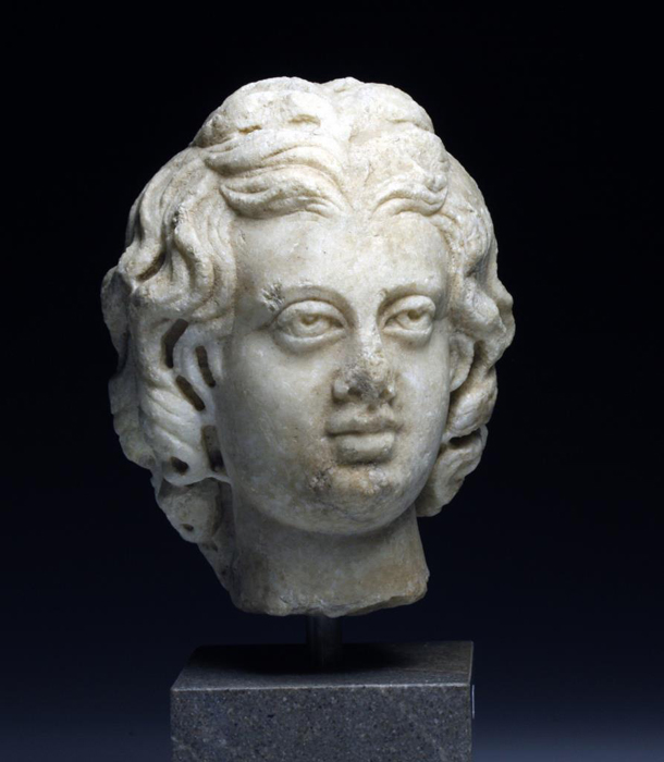Roman Marble head of Eros, Antonine Period, est. $15,000-$20,000. Antiquities Saleroom image.